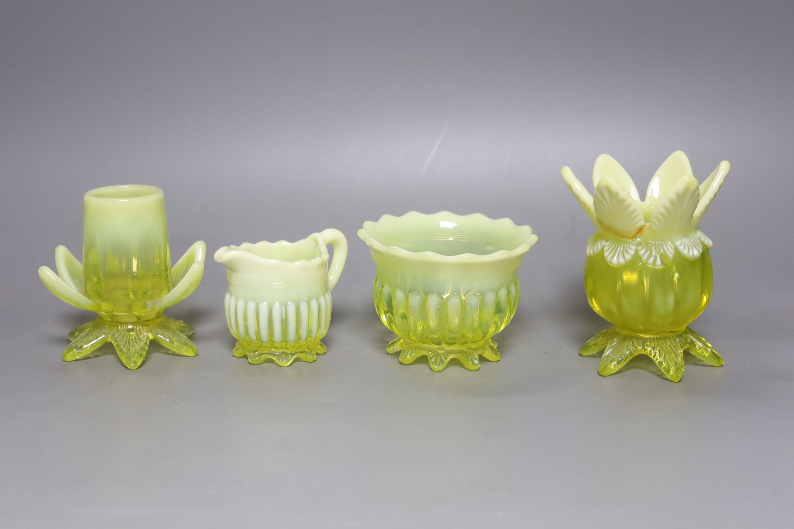 A group of assorted vaseline glass items, tallest 20cm